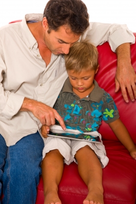 Father teaching child how to use computer